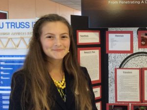 Picture of Sarah McCreary at project presentation board